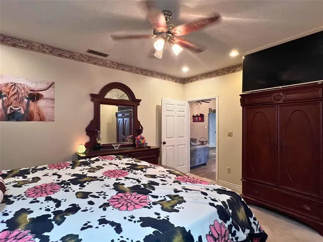 a bedroom with a bed and a bathroom with a sink