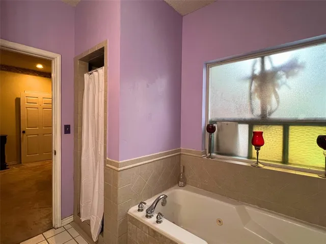 a bathroom with a tub and shower