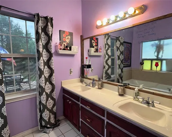 a bathroom with a sink vanity granite and a mirror