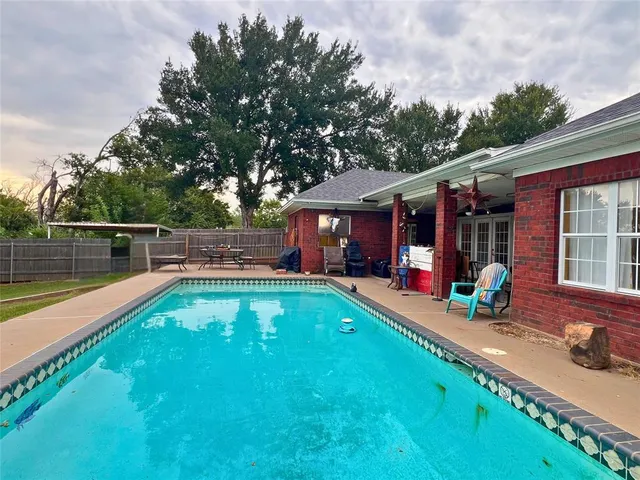 a view of a swimming pool with a patio