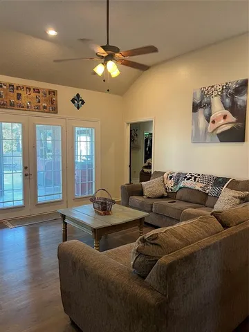 a living room with furniture and a chandelier