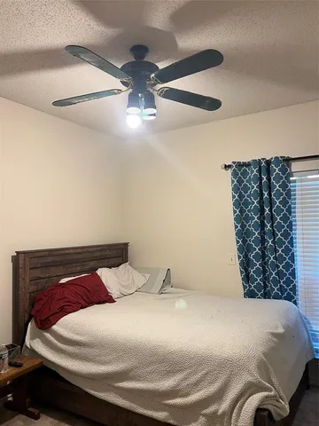 a bedroom with a bed and a large mirror