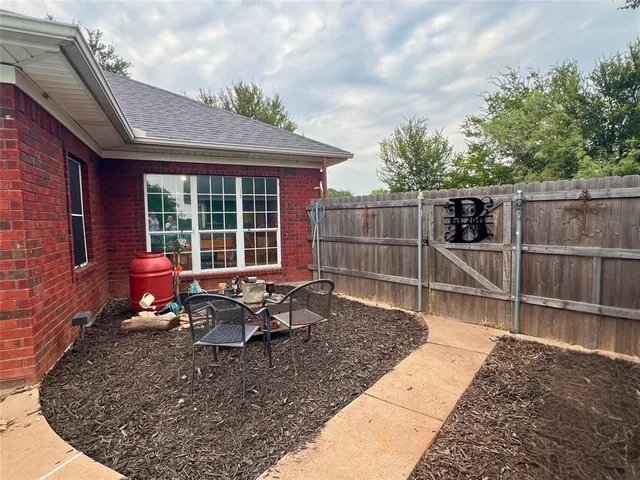 a view of a lounge chair in the back yard of the house