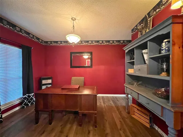 a dining room with furniture and wooden floor