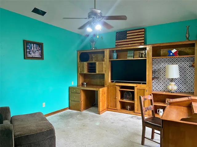 a living room with stainless steel appliances kitchen island furniture and a fireplace