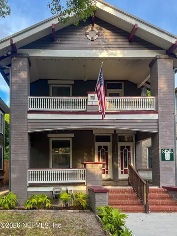 a view of a house with a door and wooden floor