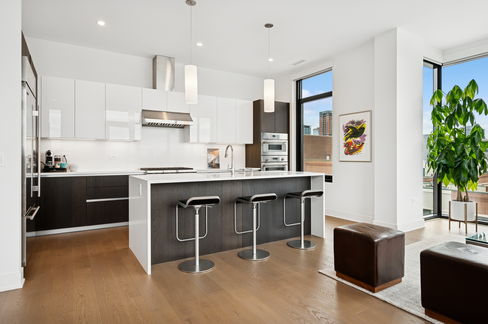 6 North Bishop Street, Unit 401 Chicago, IL 60607 - Photo 11 of 45 a kitchen with stainless steel appliances kitchen island granite countertop a table chairs sink and cabinets