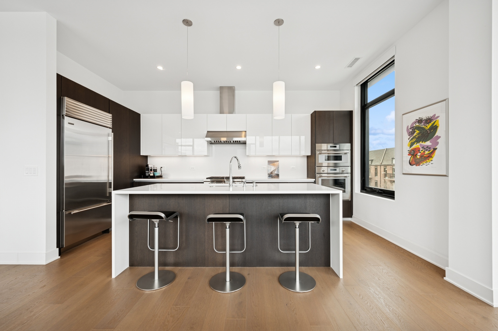 6 North Bishop Street, Unit 401 Chicago, IL 60607 - Photo 15 of 45 a kitchen with granite countertop a refrigerator and microwave