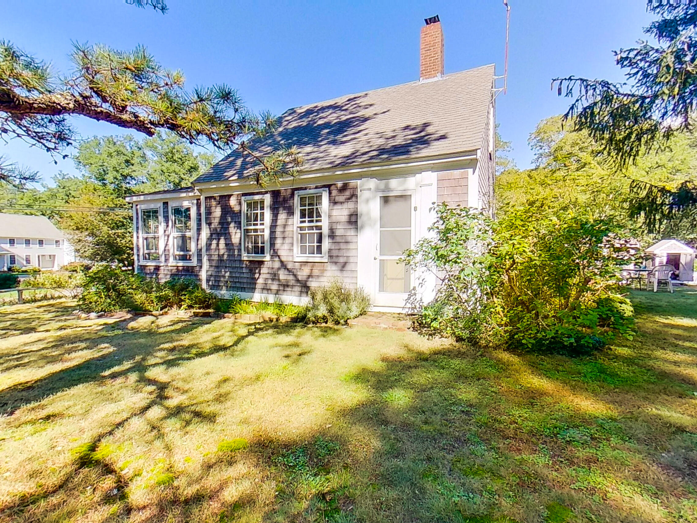 115 Cove Road Wellfleet, MA 02667 - Photo 1 of 49 a view of a house with a big yard and potted plants