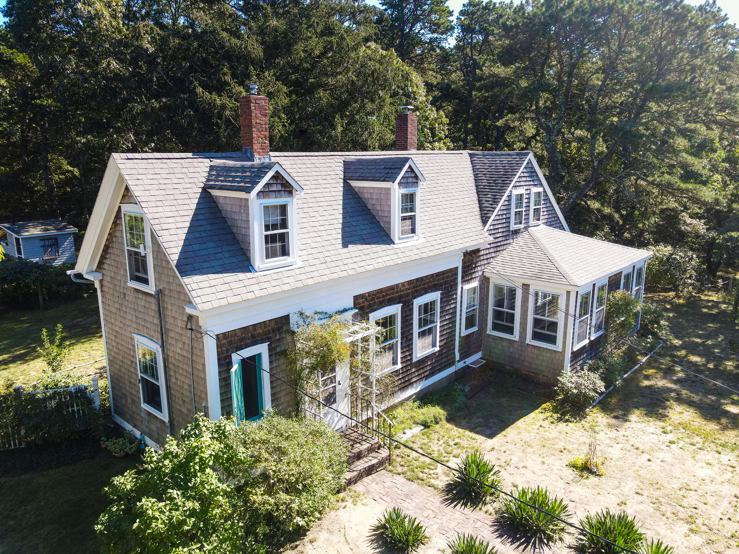 115 Cove Road Wellfleet, MA 02667 - Photo 2 of 49 front view of a house with a yard