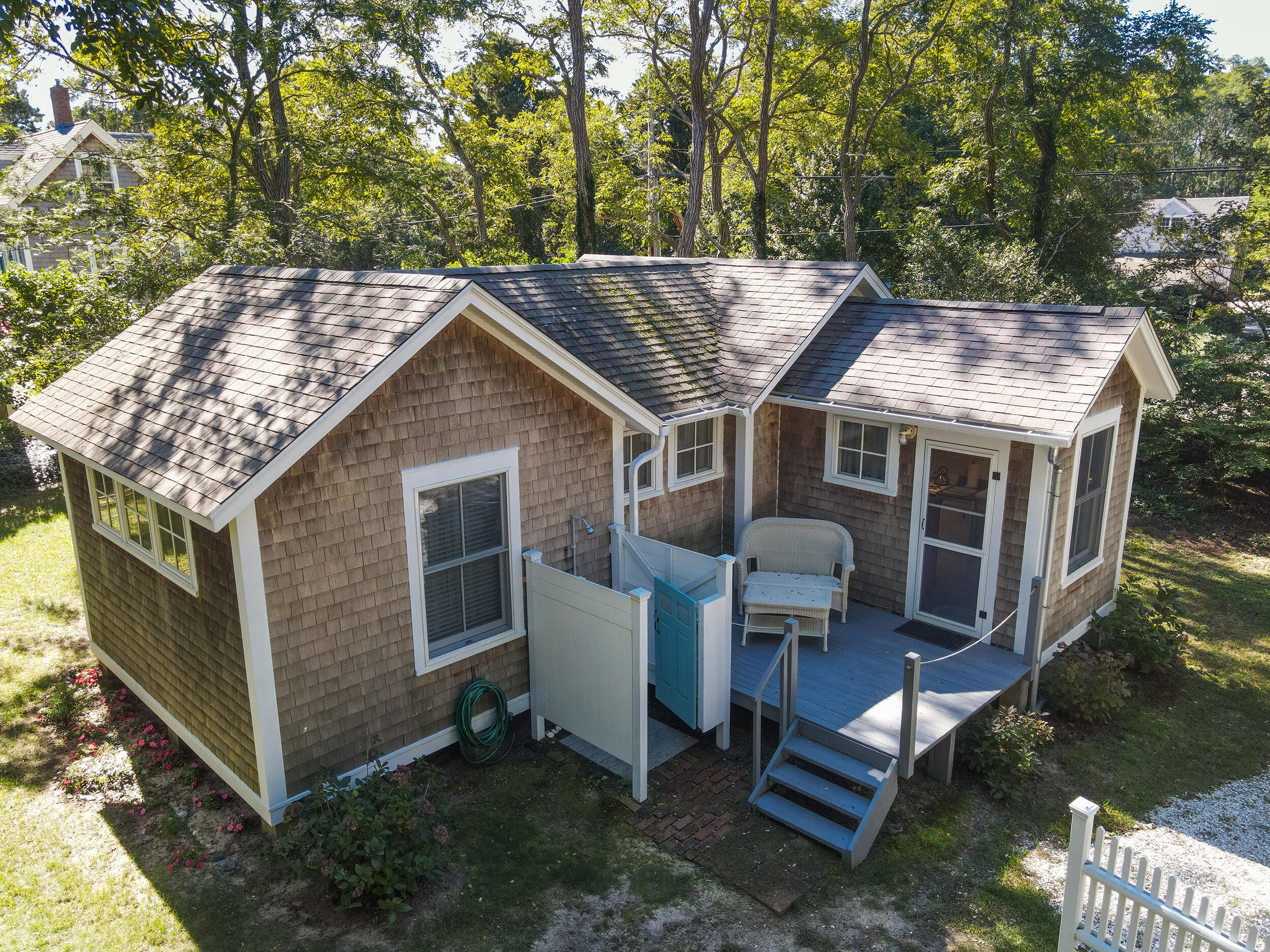 115 Cove Road Wellfleet, MA 02667 - Photo 33 of 49 a backyard of a house with barbeque oven stove and outdoor seating