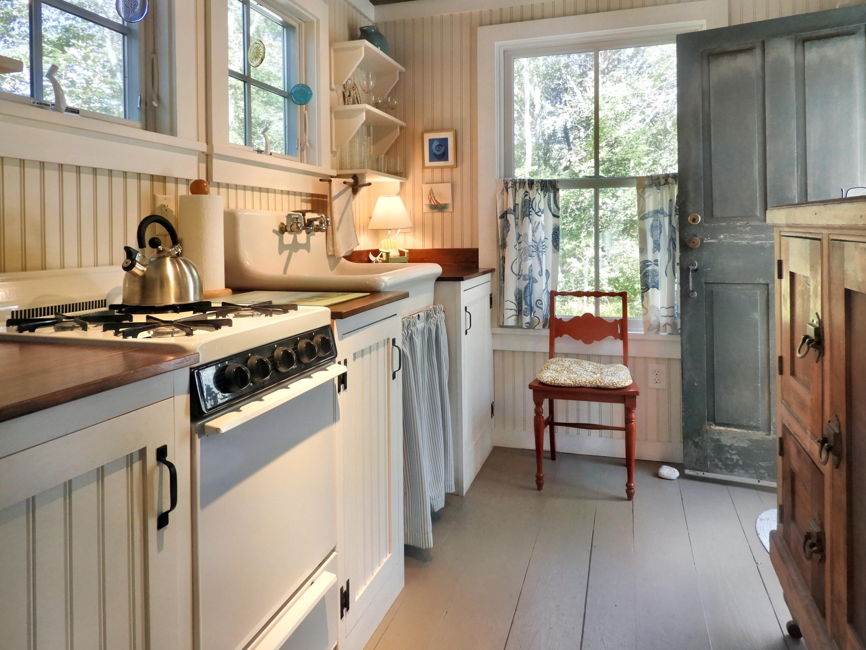 115 Cove Road Wellfleet, MA 02667 - Photo 34 of 49 a kitchen with stainless steel appliances granite countertop a stove and a refrigerator
