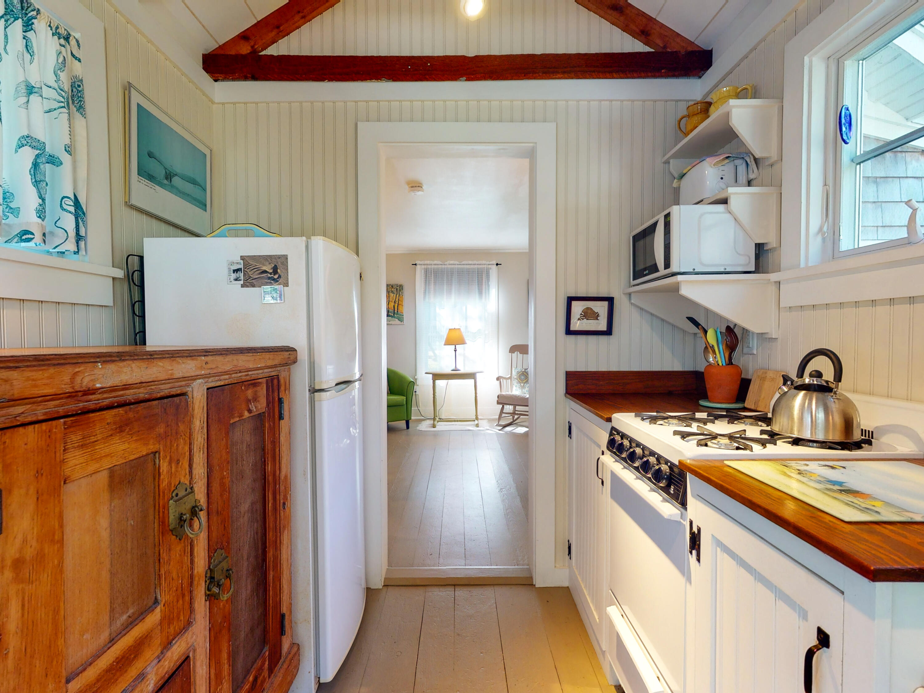 115 Cove Road Wellfleet, MA 02667 - Photo 36 of 49 a kitchen with stainless steel appliances granite countertop a stove a sink and a refrigerator