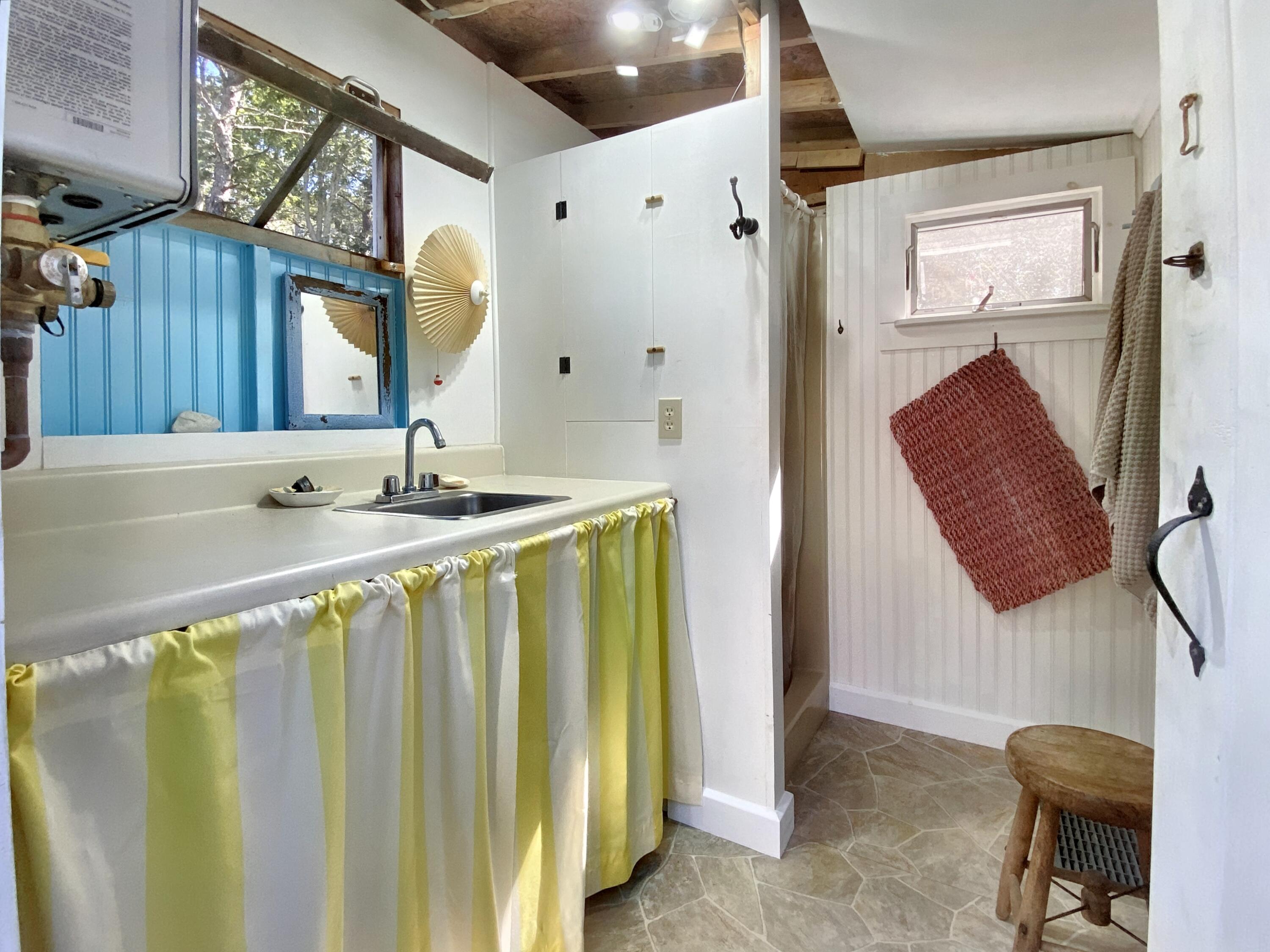 115 Cove Road Wellfleet, MA 02667 - Photo 42 of 49 a bathroom with a sink a mirror and a shower