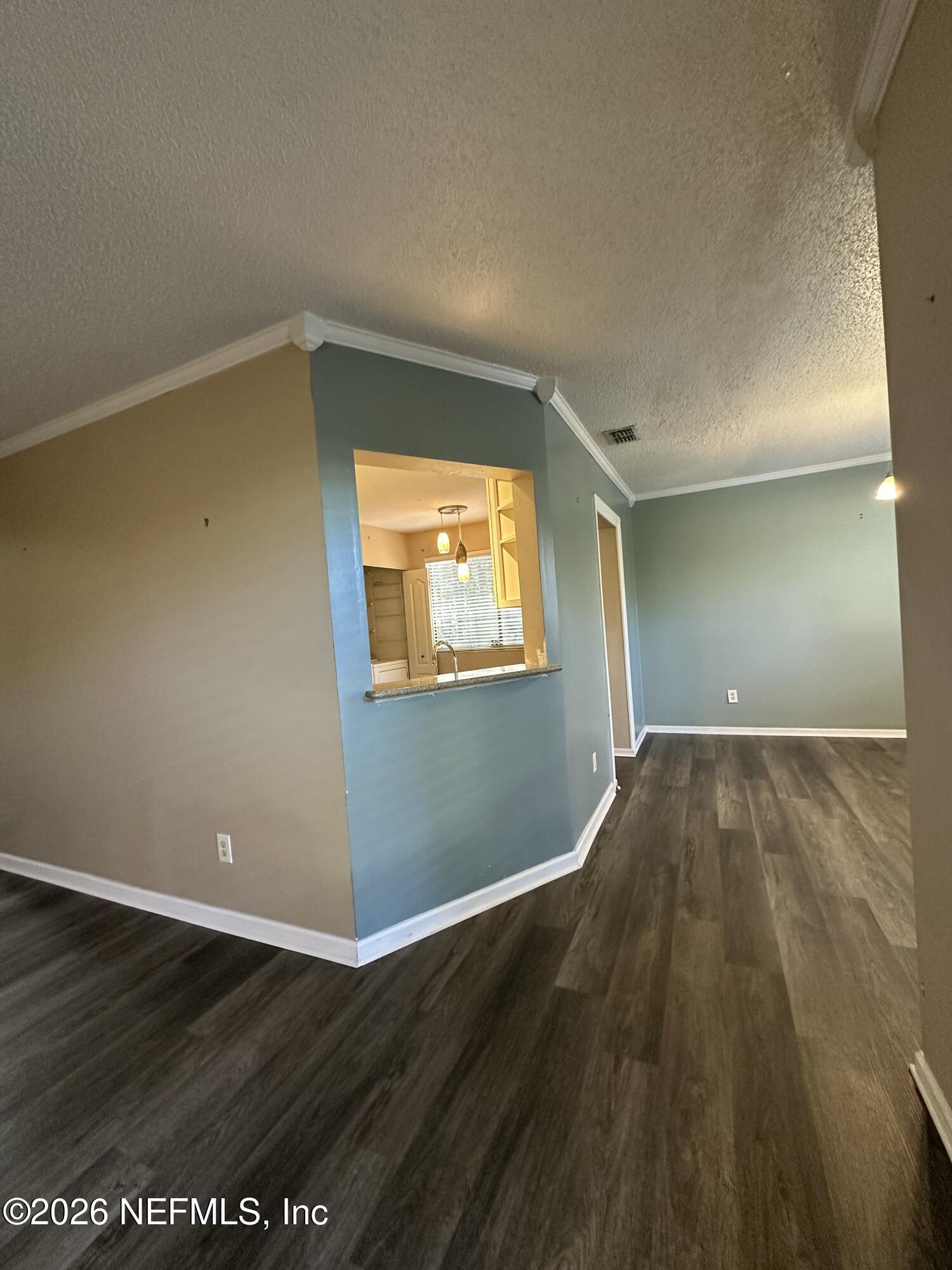 3801 Crown Point Road, Unit 3081 Jacksonville, FL 32257 - Photo 13 of 34 a view of an empty room with wooden floor and a window