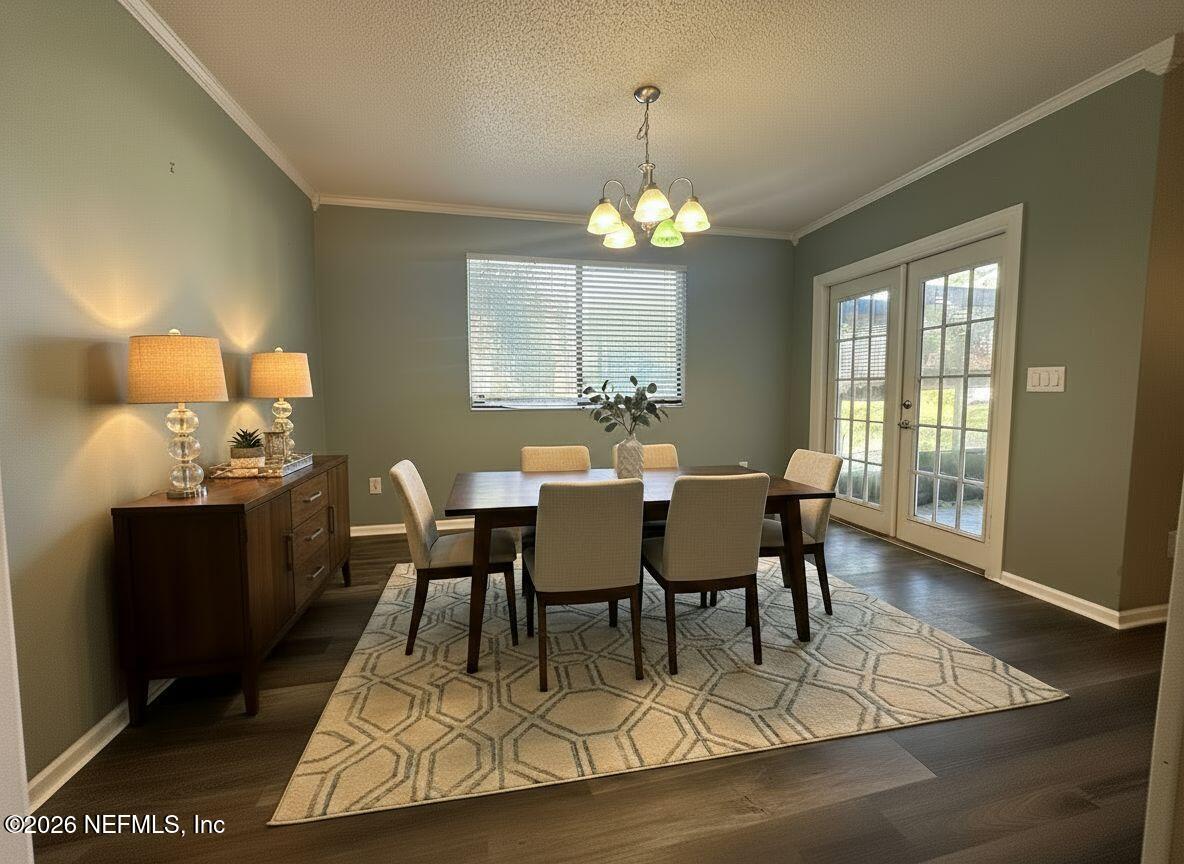 3801 Crown Point Road, Unit 3081 Jacksonville, FL 32257 - Photo 16 of 34 a view of a dining room with furniture a chandelier and wooden floor