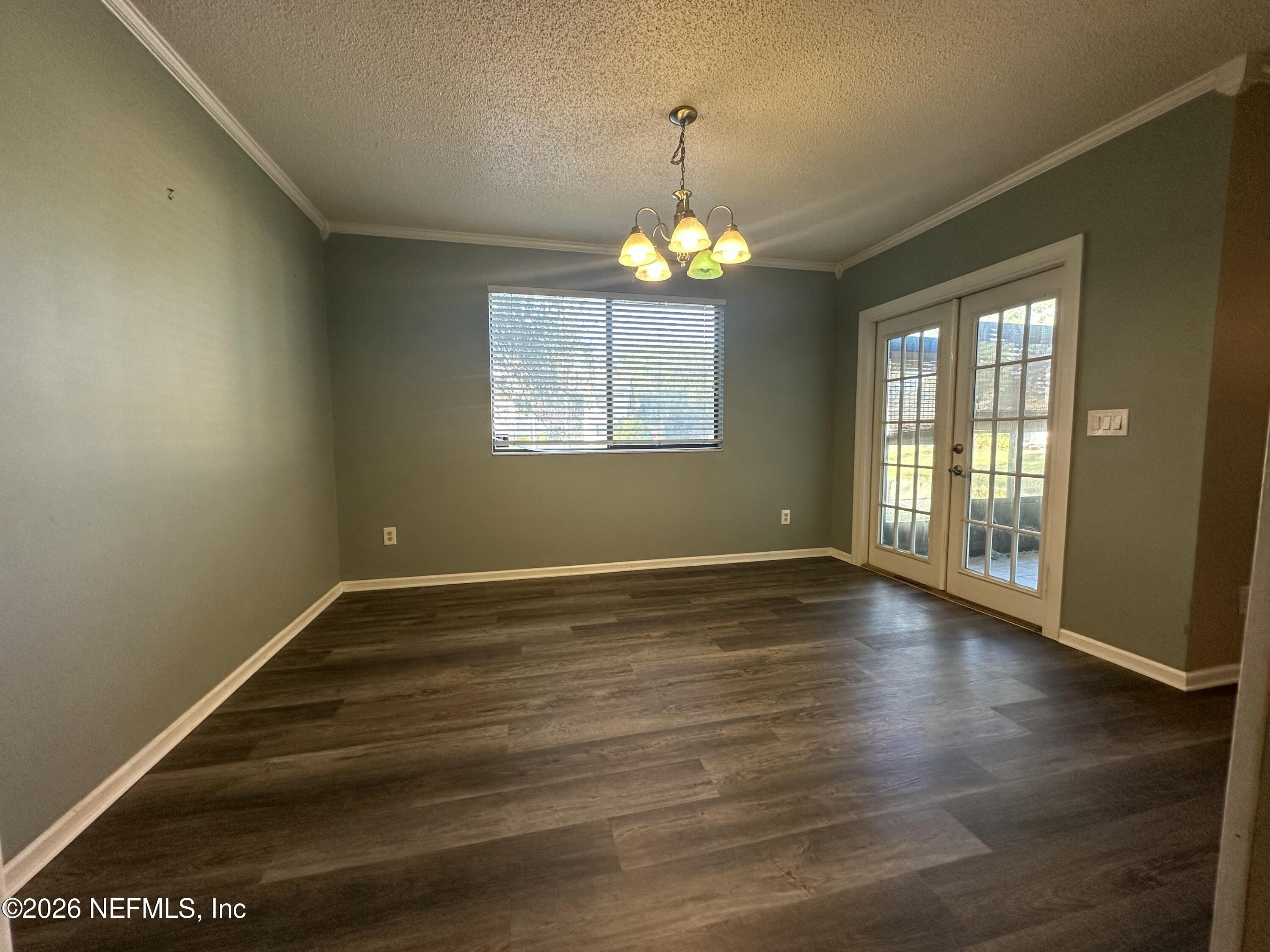 3801 Crown Point Road, Unit 3081 Jacksonville, FL 32257 - Photo 17 of 34 a view of an empty room with wooden floor and a window