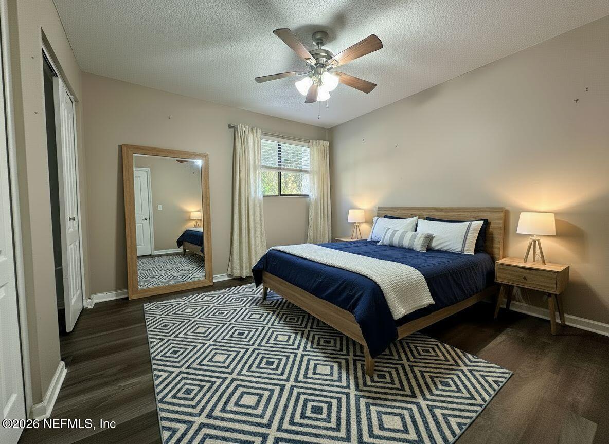 3801 Crown Point Road, Unit 3081 Jacksonville, FL 32257 - Photo 19 of 34 a bedroom with a large bed and a chandelier