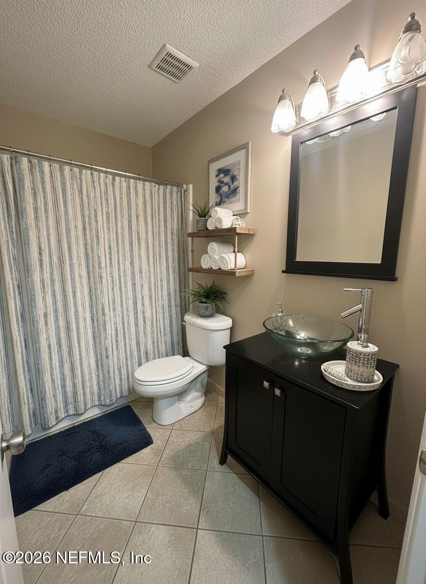 3801 Crown Point Road, Unit 3081 Jacksonville, FL 32257 - Photo 20 of 34 a bathroom with a toilet sink and mirror