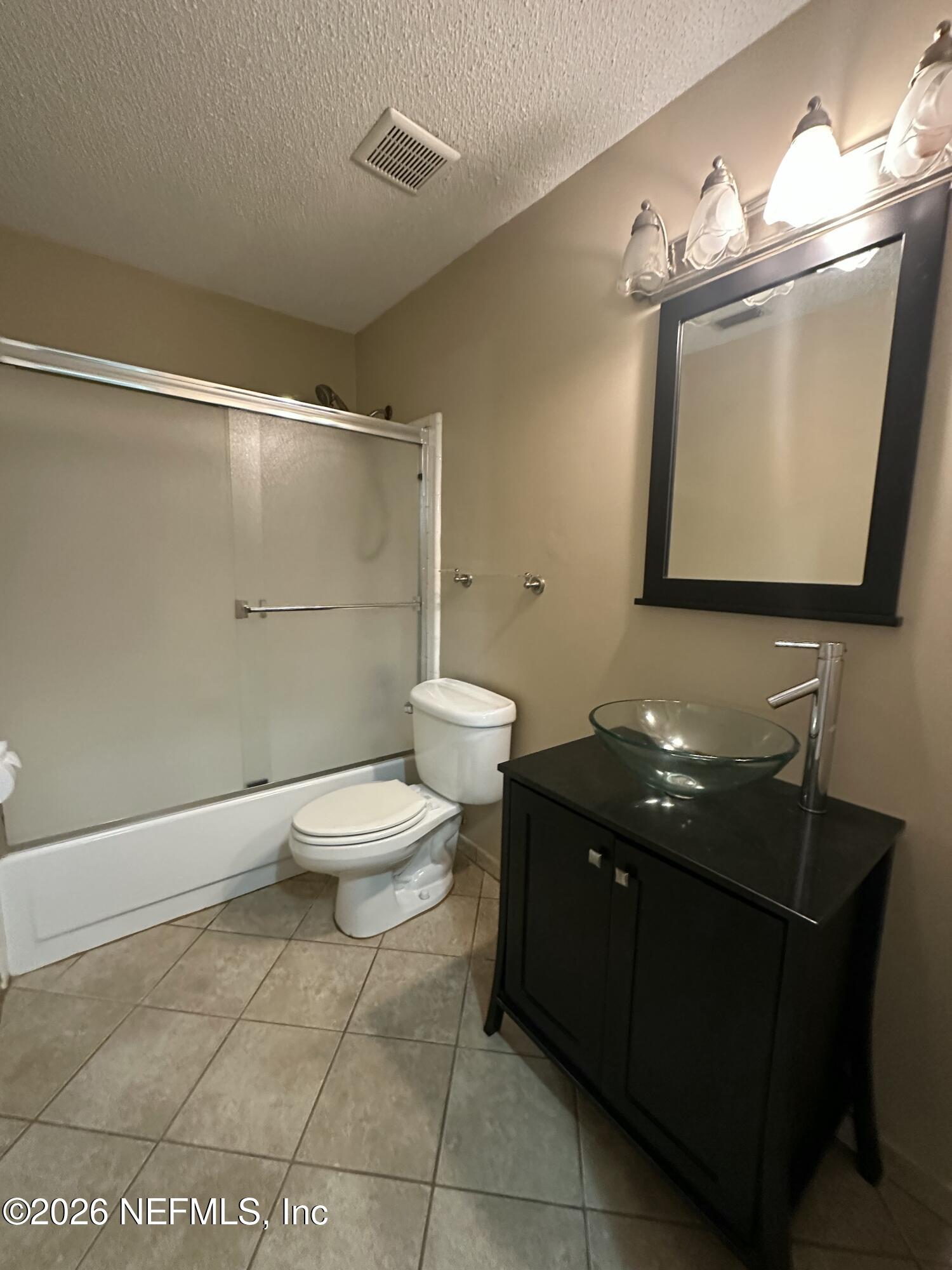 3801 Crown Point Road, Unit 3081 Jacksonville, FL 32257 - Photo 21 of 34 a bathroom with a toilet sink and mirror