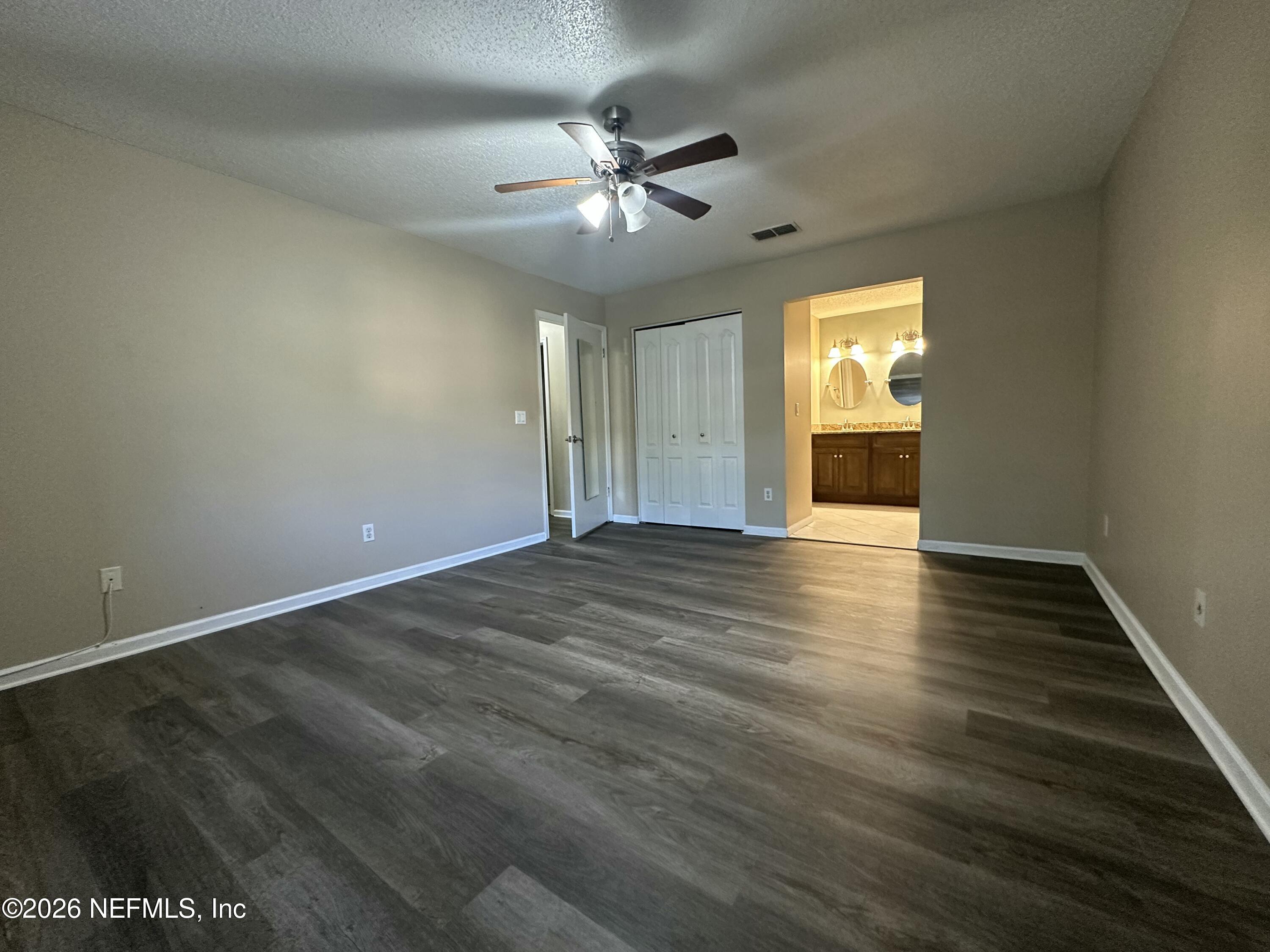3801 Crown Point Road, Unit 3081 Jacksonville, FL 32257 - Photo 24 of 34 an empty room with wooden floor fan and windows