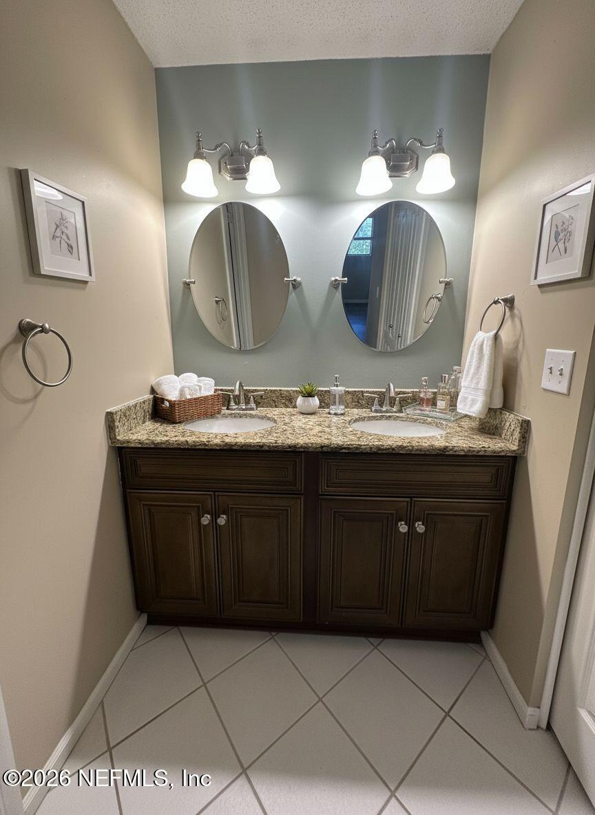 3801 Crown Point Road, Unit 3081 Jacksonville, FL 32257 - Photo 26 of 34 a bathroom with a double vanity sink and a mirror
