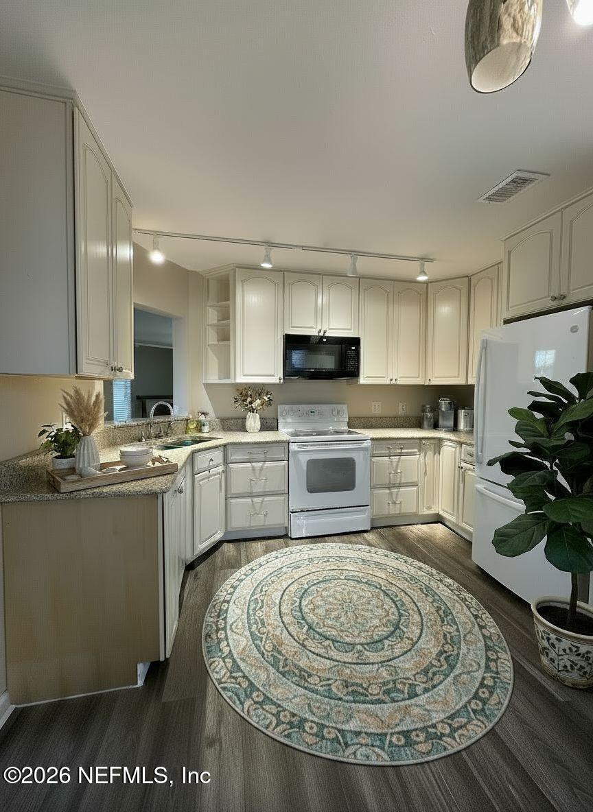3801 Crown Point Road, Unit 3081 Jacksonville, FL 32257 - Photo 3 of 34 a kitchen with a sink appliances cabinets and a counter top space