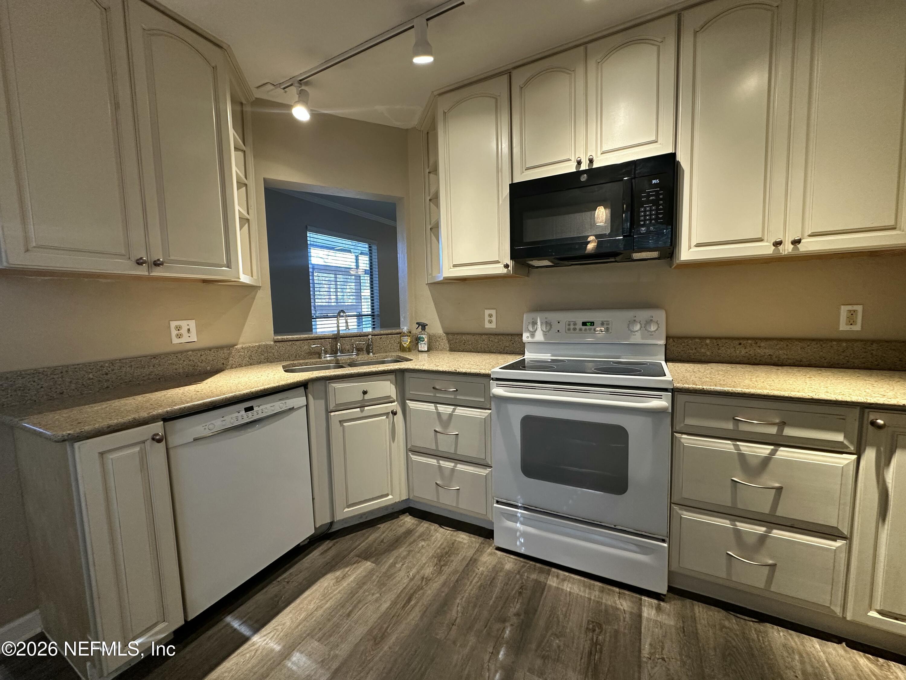 3801 Crown Point Road, Unit 3081 Jacksonville, FL 32257 - Photo 6 of 34 a kitchen with granite countertop a sink stainless steel appliances and cabinets