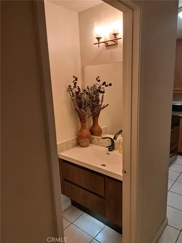 a view of bathroom with a sink and mirror