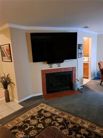 a living room with a fireplace and a flat screen tv