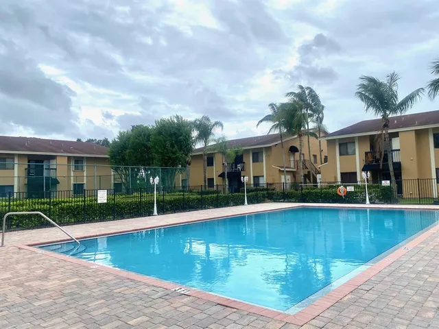 a view of a house with swimming pool and a yard
