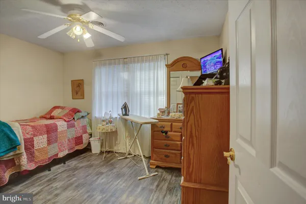 a bedroom with bed and a chandelier
