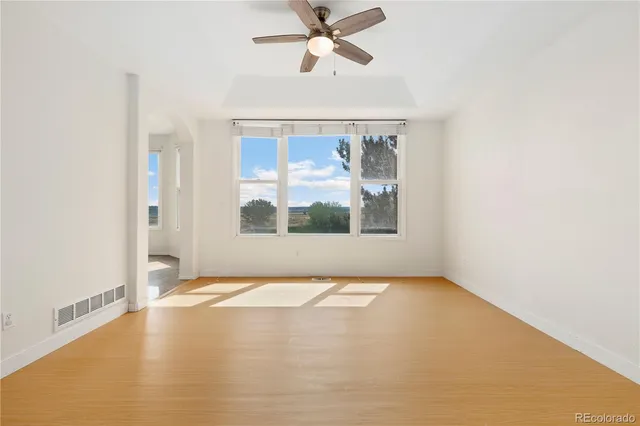 a kitchen with granite countertop white cabinets and stainless steel appliances