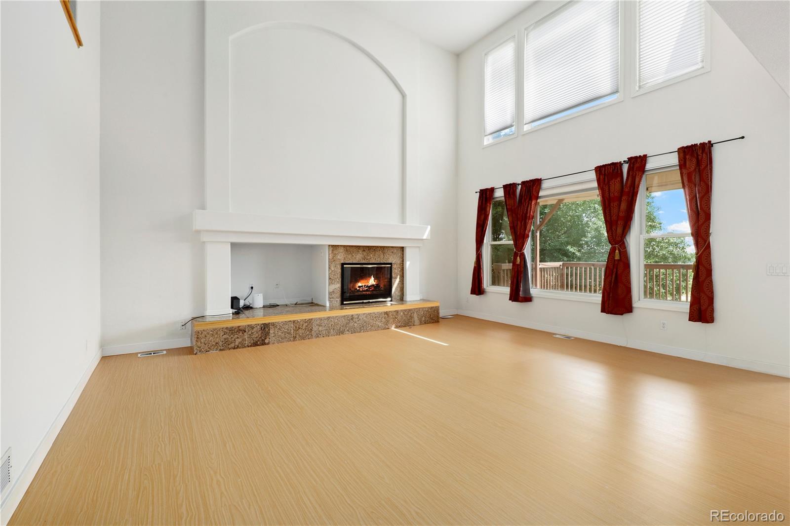 5662 South Nome Street Englewood, CO 80111 - Photo 24 of 47 an empty room with windows and fireplace