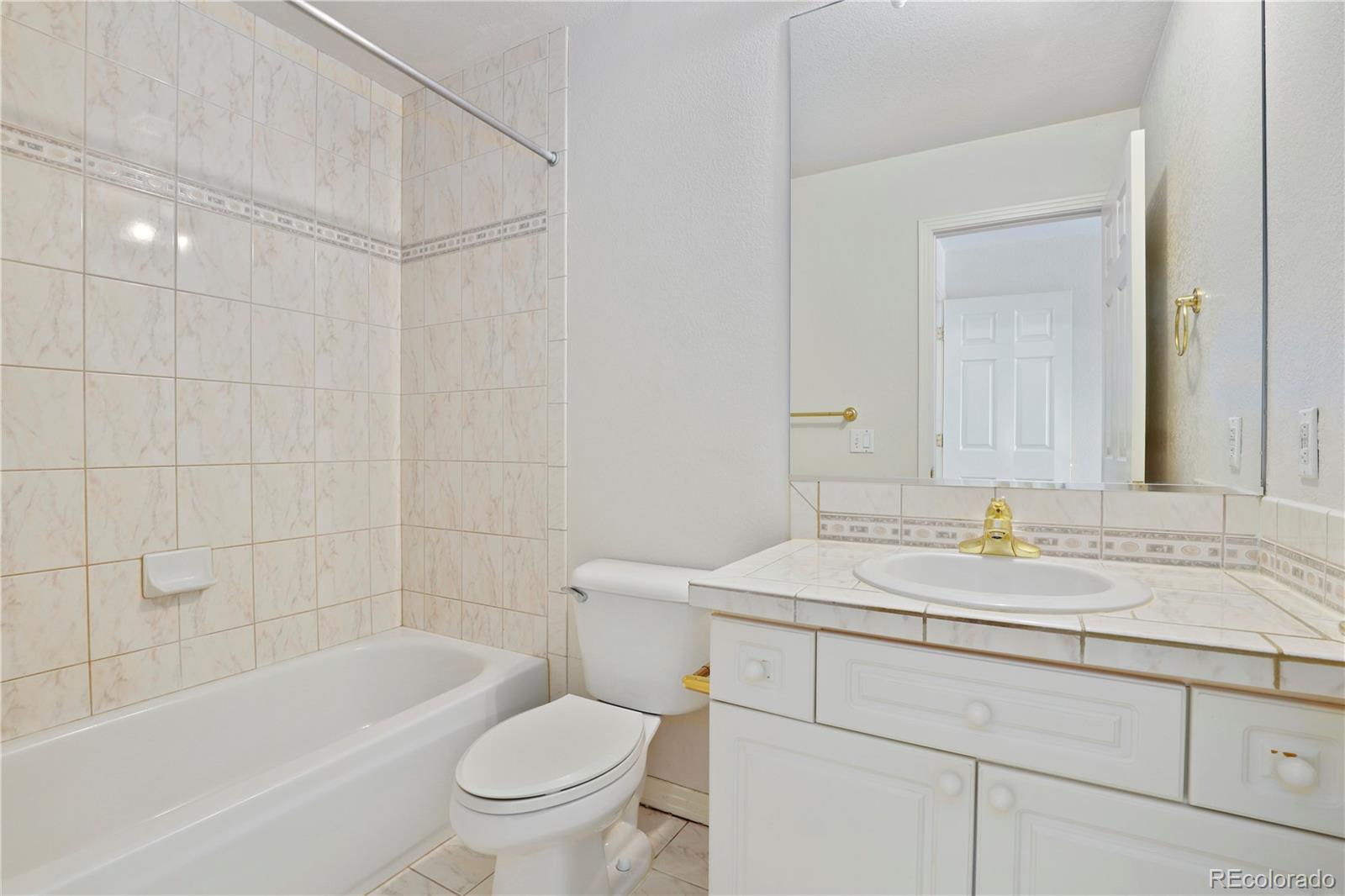 5662 South Nome Street Englewood, CO 80111 - Photo 26 of 47 a bathroom with a sink a toilet and a bathtub