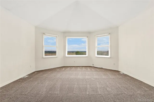 a spacious bathroom with a granite countertop sink a toilet a mirror and shower