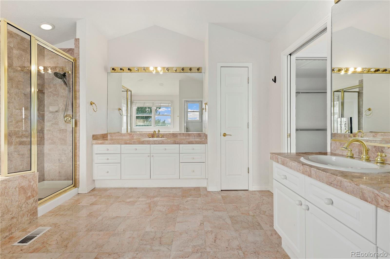 5662 South Nome Street Englewood, CO 80111 - Photo 36 of 47 a spacious bathroom with a granite countertop sink a toilet a mirror and shower