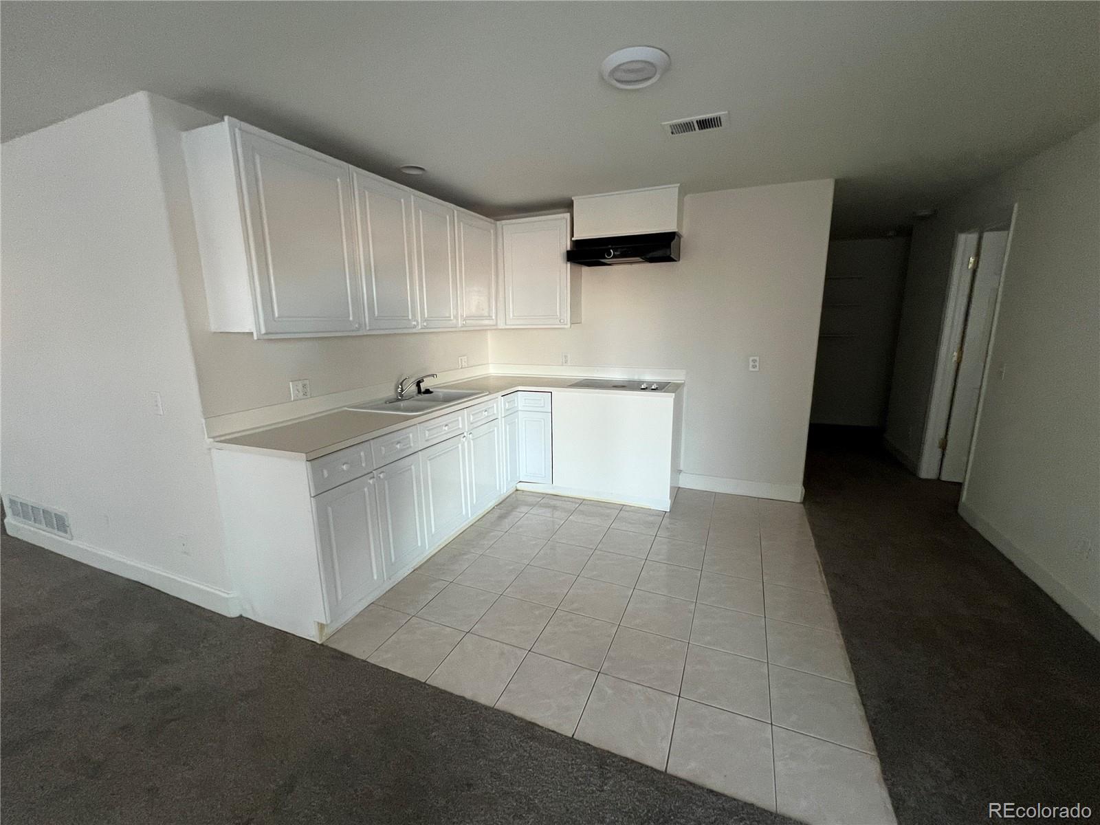 5662 South Nome Street Englewood, CO 80111 - Photo 40 of 47 a kitchen with a cabinets and white appliances