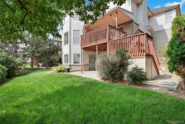 a view of a house with backyard and sitting area