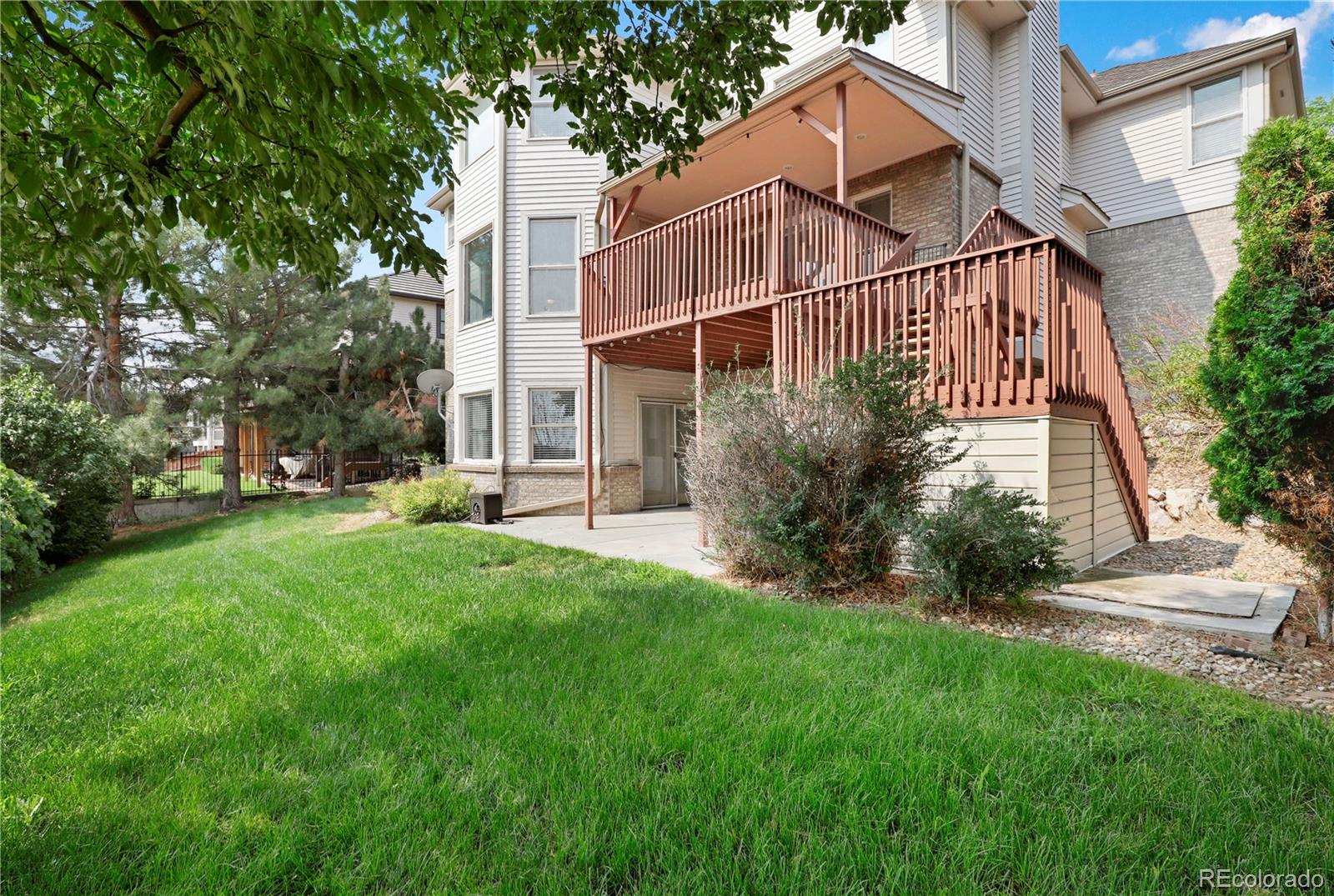 5662 South Nome Street Englewood, CO 80111 - Photo 4 of 47 a view of a house with a small yard and large trees
