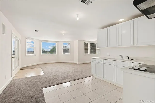 a spacious bathroom with a double vanity sink a toilet and a bathtub