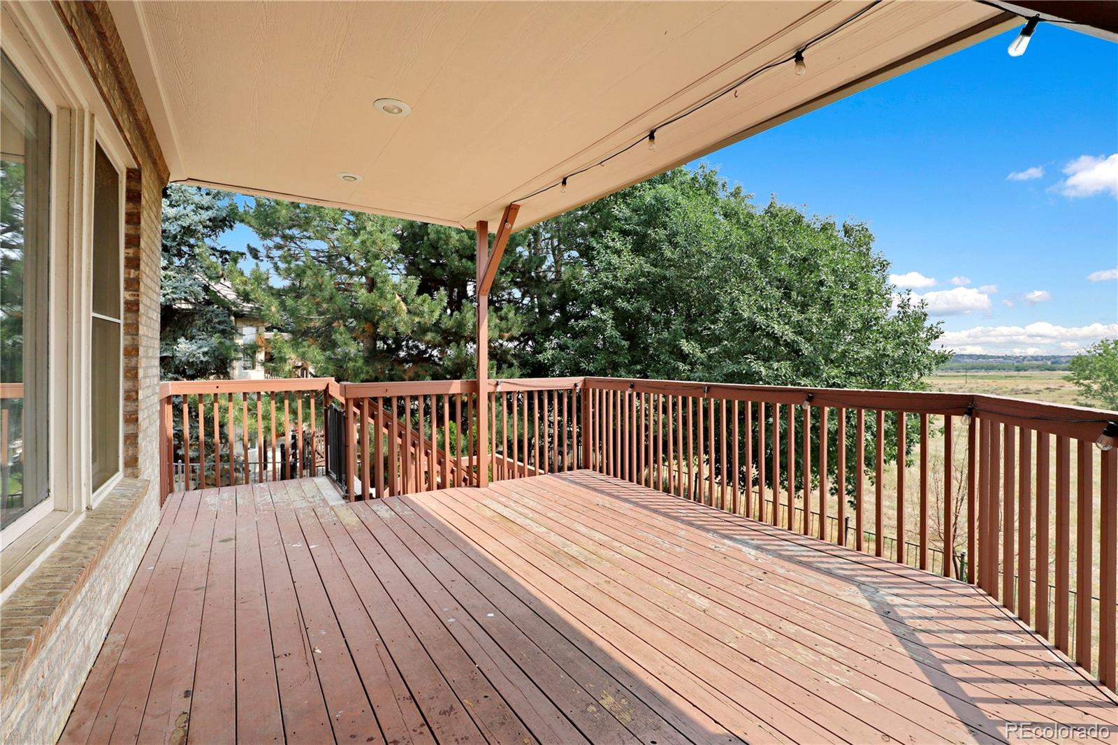 5662 South Nome Street Englewood, CO 80111 - Photo 7 of 47 a balcony with trees in front of it