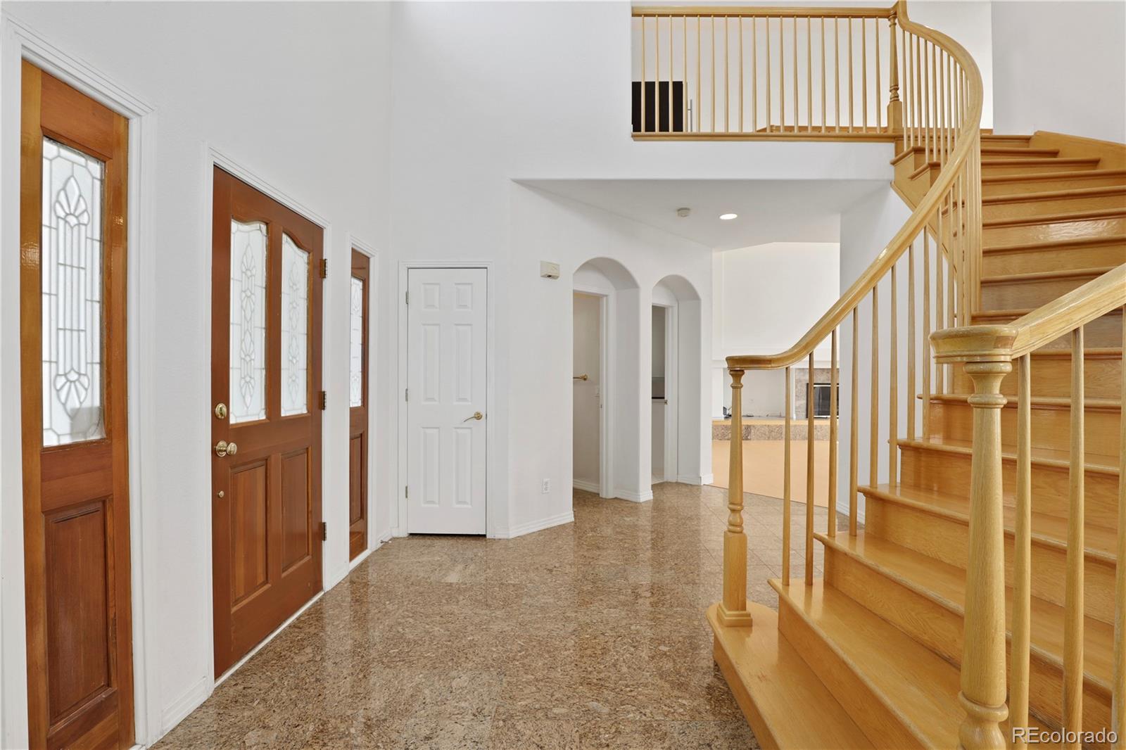 5662 South Nome Street Englewood, CO 80111 - Photo 9 of 47 a view of entryway with wooden floor and stairs