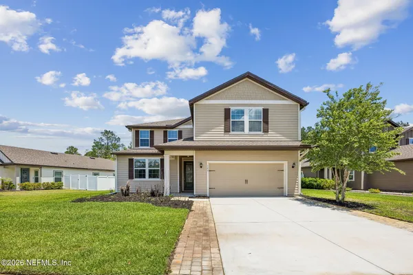 a front view of a house with a yard and garage