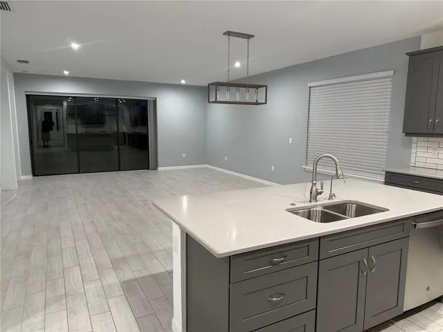 a bathroom with a granite countertop sink toilet a mirror and shower