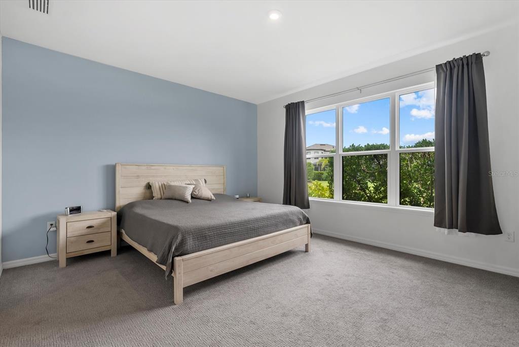 9291 Starry Night Avenue Sarasota, FL 34241 - Photo 14 of 30 a bed sitting in a bedroom next to a window