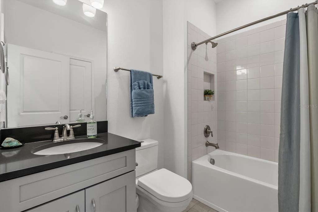 9291 Starry Night Avenue Sarasota, FL 34241 - Photo 17 of 30 a bathroom with a granite countertop sink toilet and shower