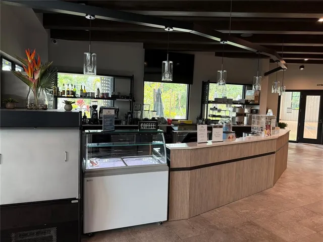 a view of a patio with table and chairs couches with wooden floor