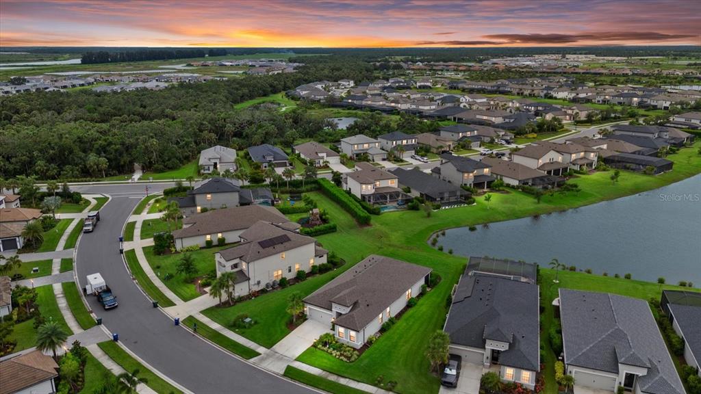 9291 Starry Night Avenue Sarasota, FL 34241 - Photo 3 of 30 an aerial view of a city with lots of residential buildings and mountain view in back