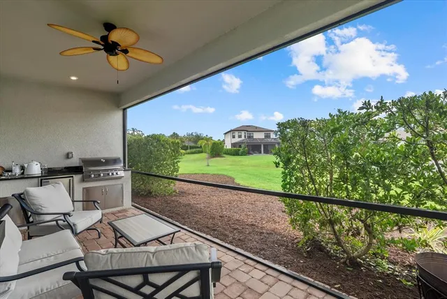 a view of a chairs and table in patio with a yard